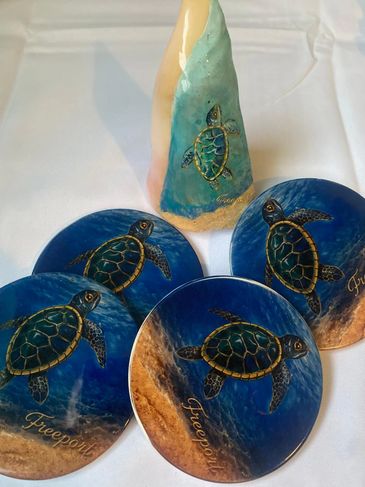 Artistic sea turtle-themed coasters and a matching decorative cone.