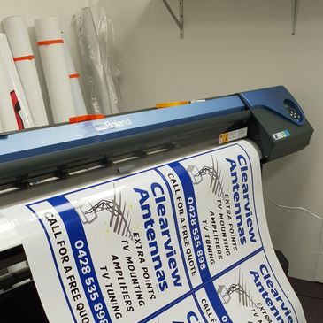 Large format Digital printer in print workshop, Hobart, Tasmania. Printing signs and laminating them