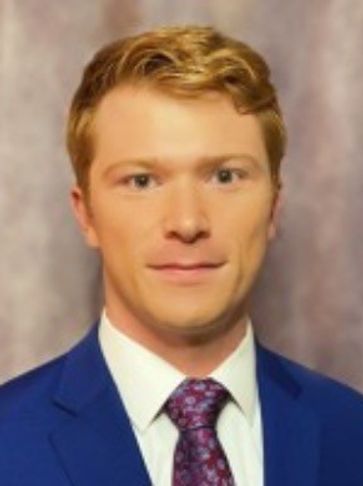 Portrait of a young man in a blue suit.