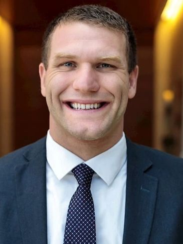 Smiling man in a suit and tie.
