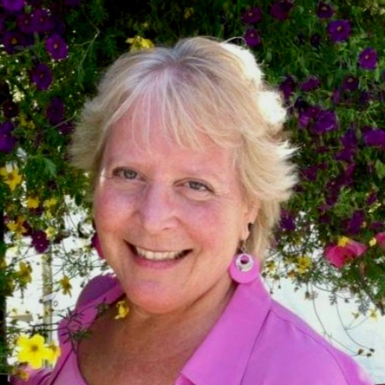 A picture of Nanci, a white woman with blonde hair, smiling at the camera.