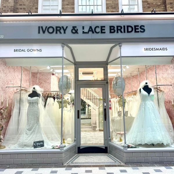 Front view of a bridal dress shop with wedding gowns displayed.