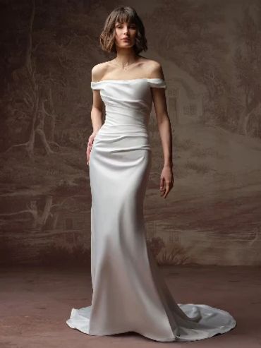 Woman in elegant off-shoulder white gown.