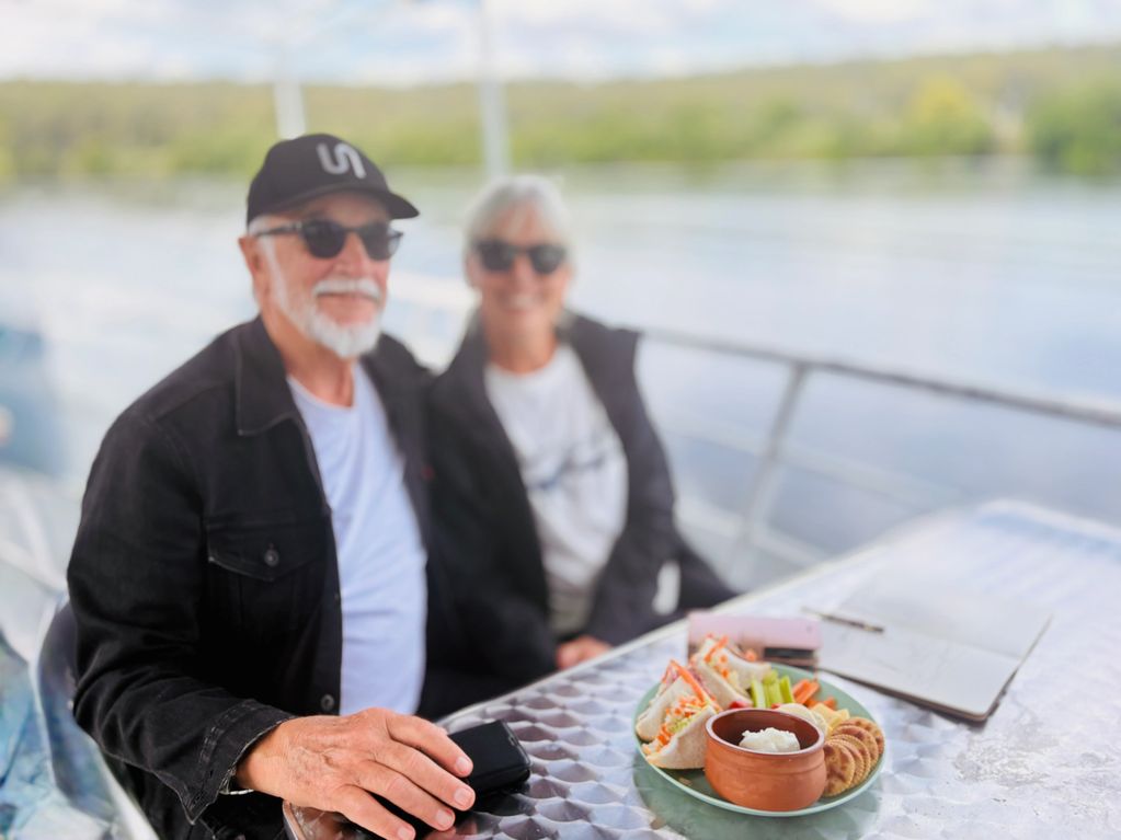 Happy passengers enjoying the scenery and some refreshments.