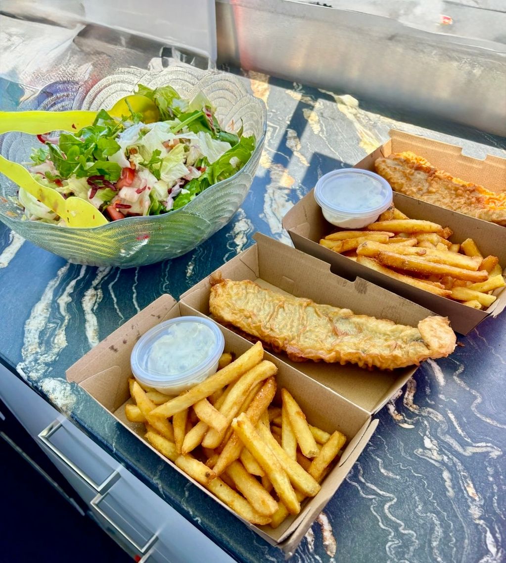 Fish and chips with salad and tartare sauce.