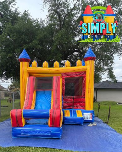Colorful inflatable bounce house with slide in a backyard.