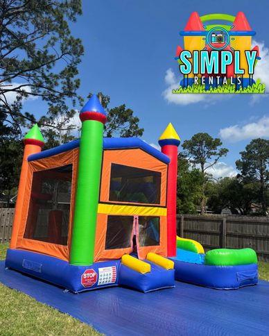 Colorful inflatable bounce house with slide in a backyard.