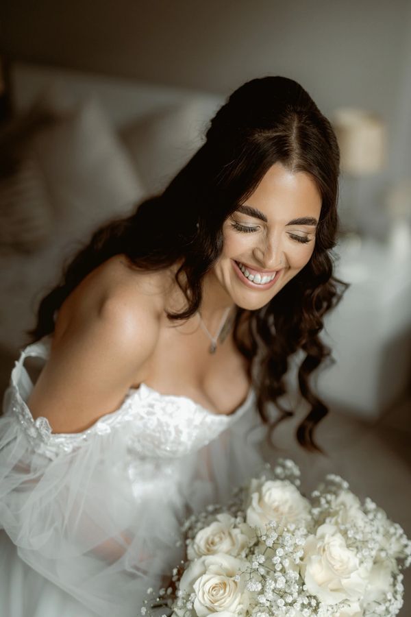 Bride smiling with her Bouquet , Eastwood Hall, Nottingham