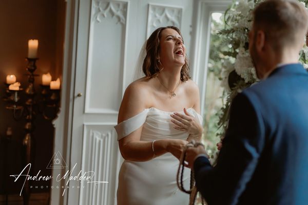 Bride laughing in wedding ceremony Didsbury House wedding, Manchester
