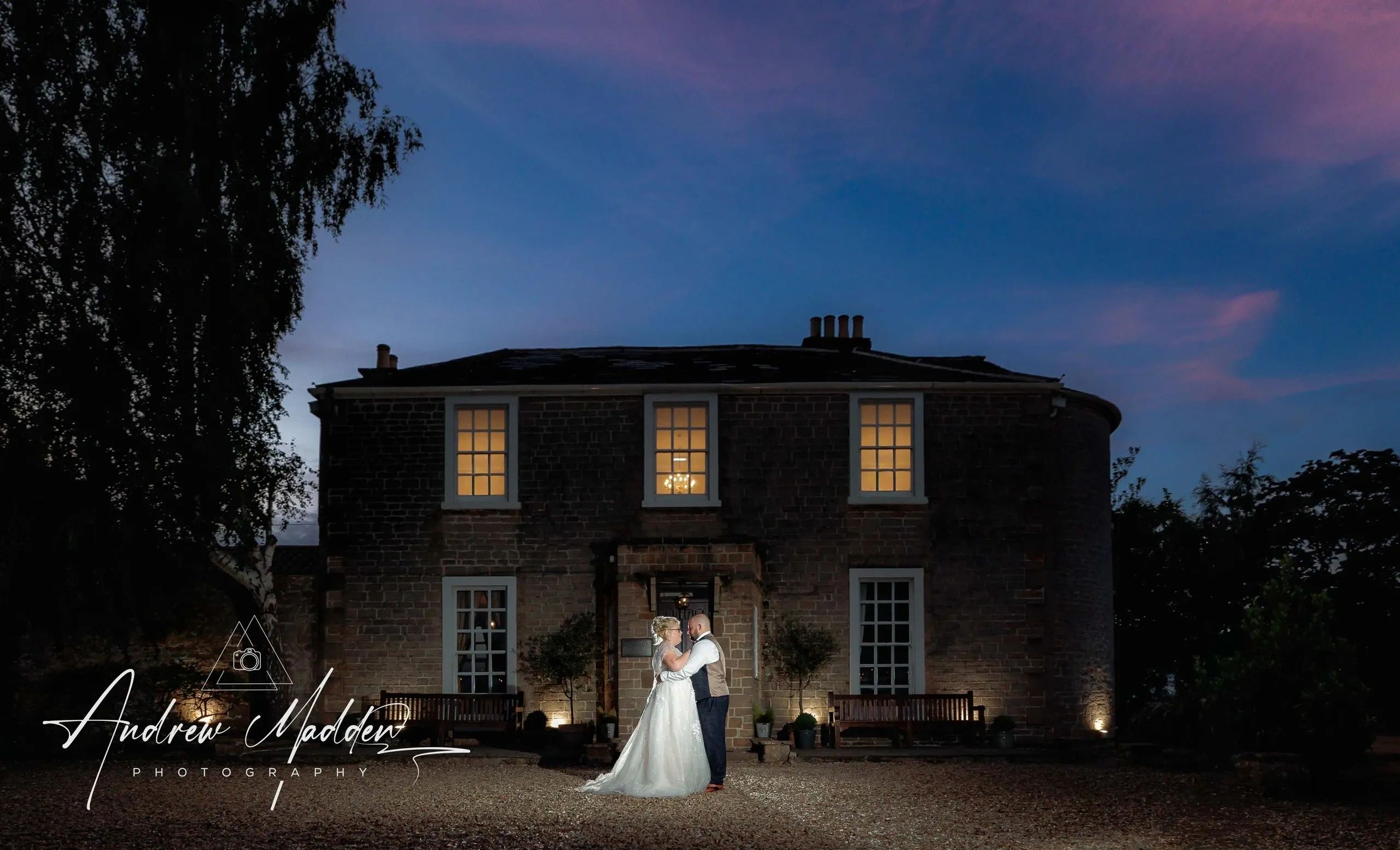 beautiful sunset with bride and groom in front off Cockliffe Country House, Nottingham