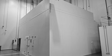 Large white industrial room or cleanroom inside a factory or warehouse.