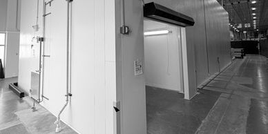 A white industrial storage container in a warehouse setting.