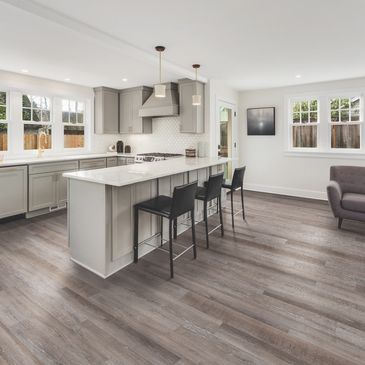 Modern kitchen with island and bar stools.