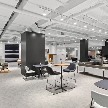 Modern furniture showroom with seating areas and minimalist decor.