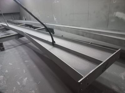 Large industrial metal beams in a workshop.