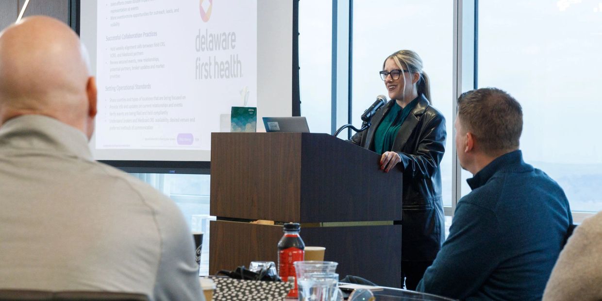 Woman presenting at a Delaware First Health event.