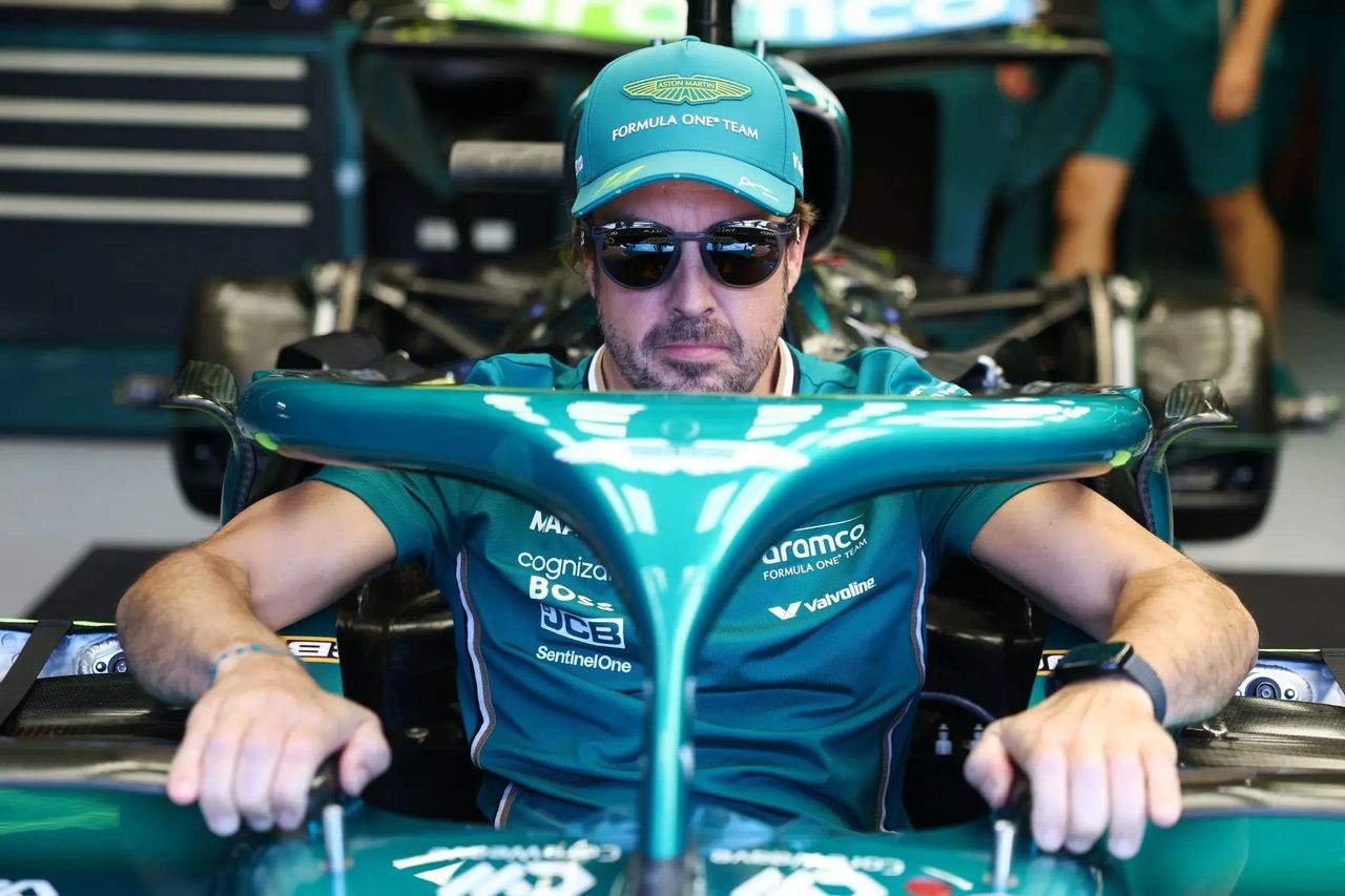 Fernando Alonso sits in the Aston Martin cockpit wearing sunglasses during Monza media day at the Italian Grand Prix 2025.