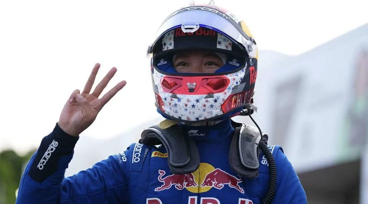 Red Bull Ford driver Chloe Chambers celebrates Montreal F1 Academy pole position with a helmeted three-finger salute, marking her third consecutive pole of the season