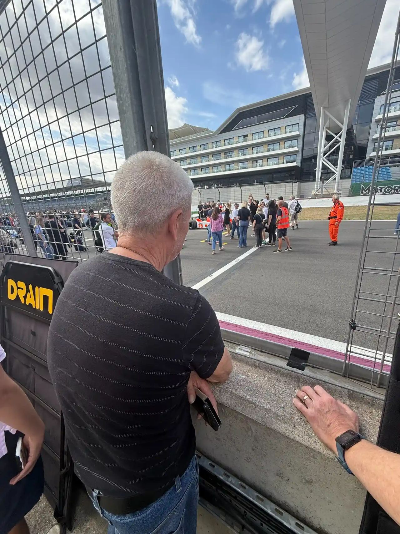 Terry Widdows’ father standing trackside at Silverstone Festival 2025, looking onto the starting grid during the final edition of the historic motorsport event.