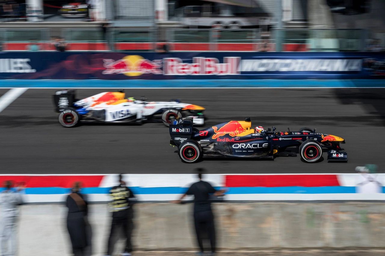 Sébastien Buemi and Isack Hadjar driving Red Bull RB7 and VCARB F1 cars at Red Bull Motormania Magny-Cours 2025.
