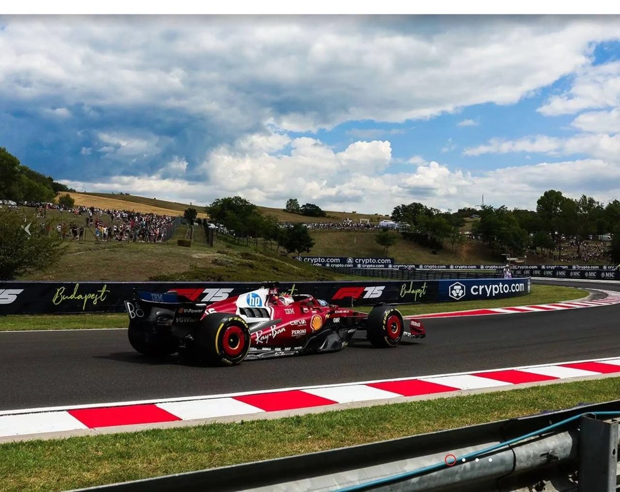 Charles Leclerc drives the Ferrari SF-25 through Turn 5 at the Hungaroring during 2025 Hungarian Grand Prix qualifying. Red and white kerbs, overcast skies, and a packed hillside crowd frame the shot. Ferrari Media image. Charles Leclerc drives the Ferrari SF-25 through Turn 5 at the Hungaroring during 2025 Hungarian Grand Prix qualifying. Red and white kerbs, overcast skies, and a packed hillside crowd frame the shot. Ferrari Media image.