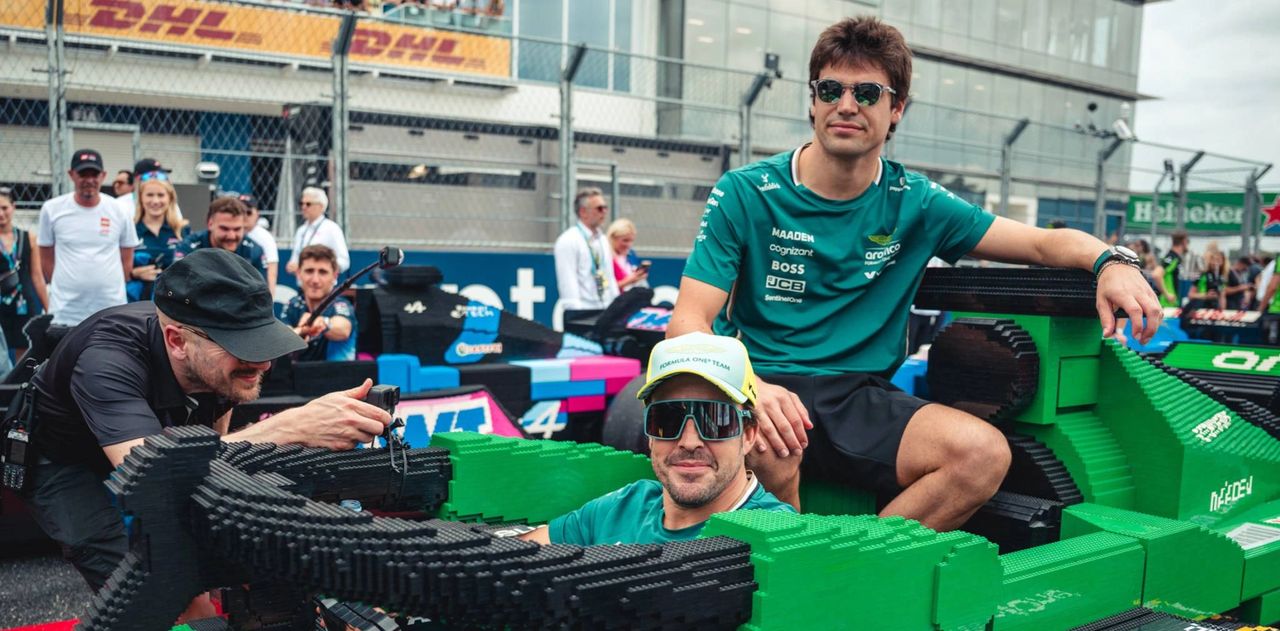 Lance Stroll and teammate Fernando Alonso pose at a Formula 1 event in 2025, representing Aston Martin. Stroll continues to lead the team's points tally this season.