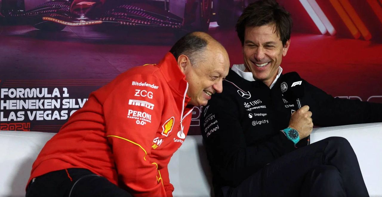 Fred Vasseur and Toto Wolff laughing during a Formula 1 press event at the Las Vegas Grand Prix 2024, symbolising mutual respect ahead of the TD018 regulation change in 2025.
