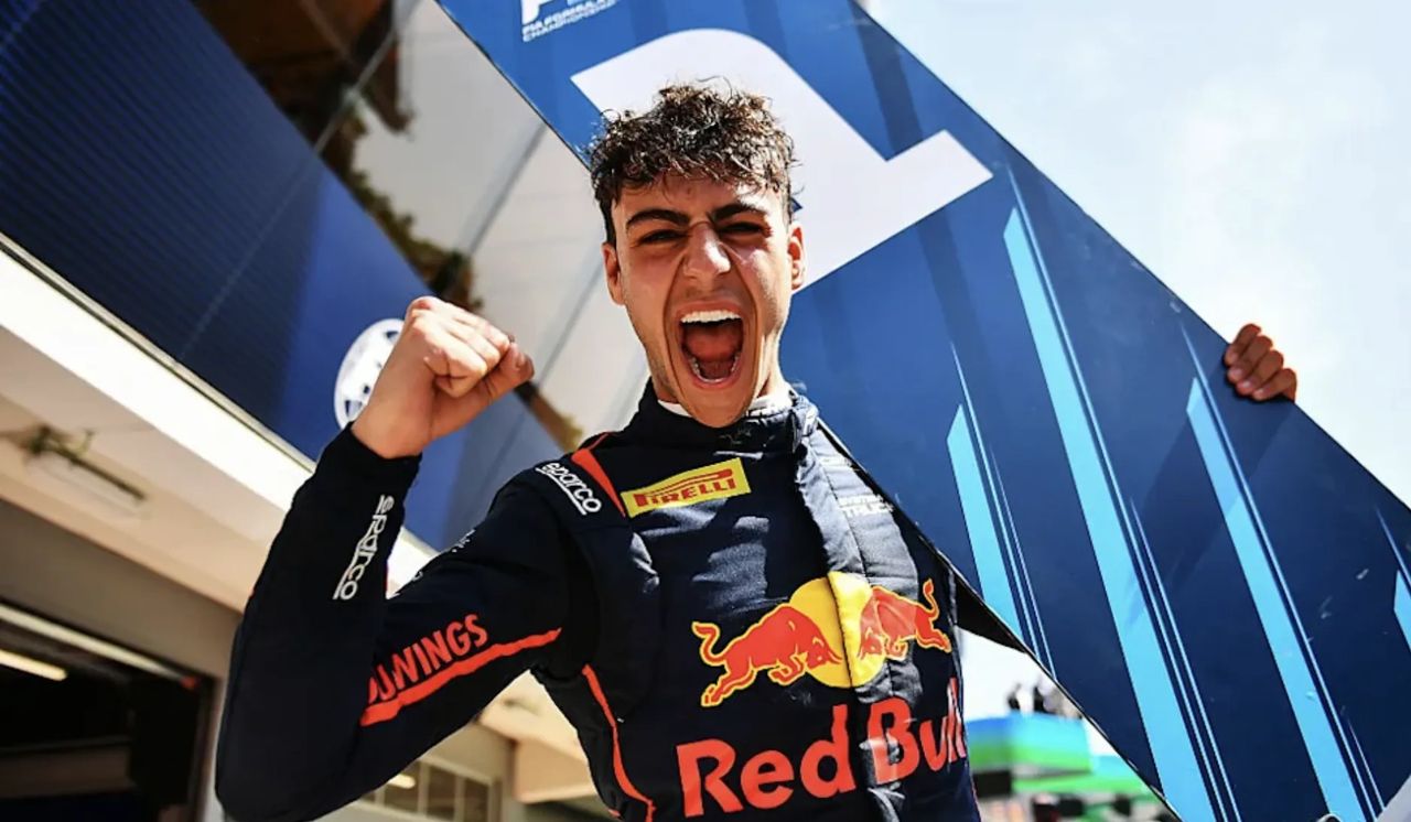 Arvid Lindblad celebrating with a number one board after winning the 2025 Formula 2 Feature Race in Barcelona for Campos Racing