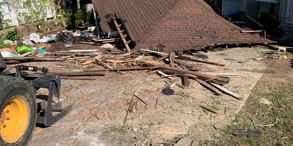 Skidsteer demolishing garage, demolition 