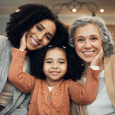 Senior, daughter, and granddaughter smiling