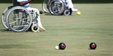 wheelchair bowlers on an outdoor bowls club