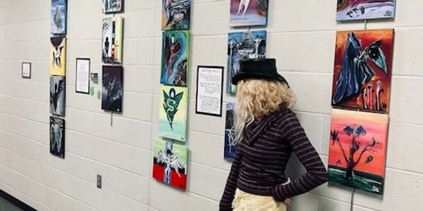 Member Tara Dunbar next to display of her art at Warrensburg Community Center, Copyright Tara Dunbar