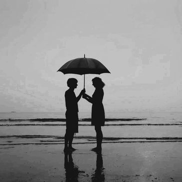 couple under an umbrella on the beach