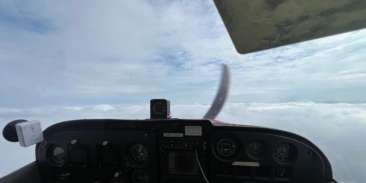 View from inside a cockpit at high altitude.