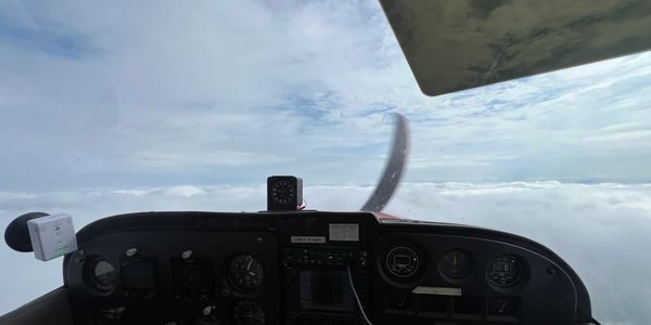 View from inside a cockpit at high altitude.