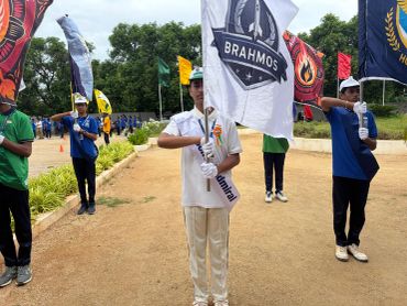 Young participants holding flags during an outdoor event.