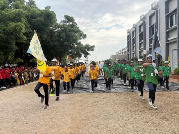 Students marching in colorful uniforms during a school event.