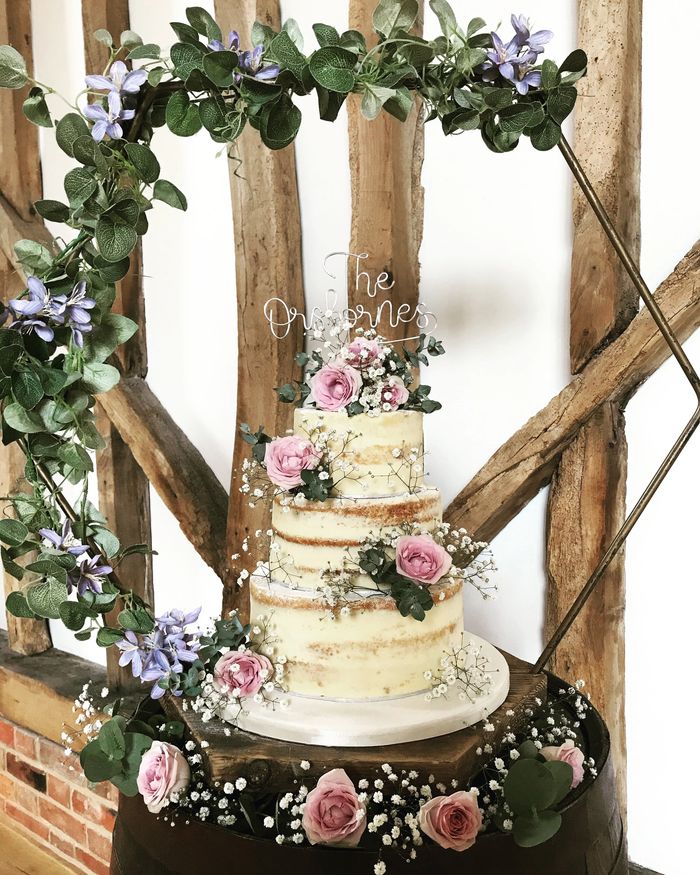 naked wedding cake wit fresh flowers