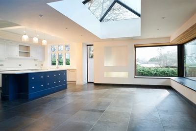 Modern kitchen with skylight and large windows.
