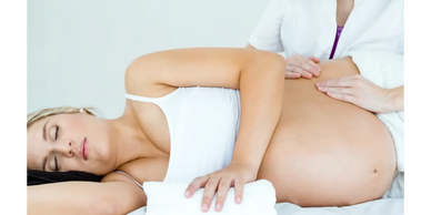 A woman receiving a prenatal massage