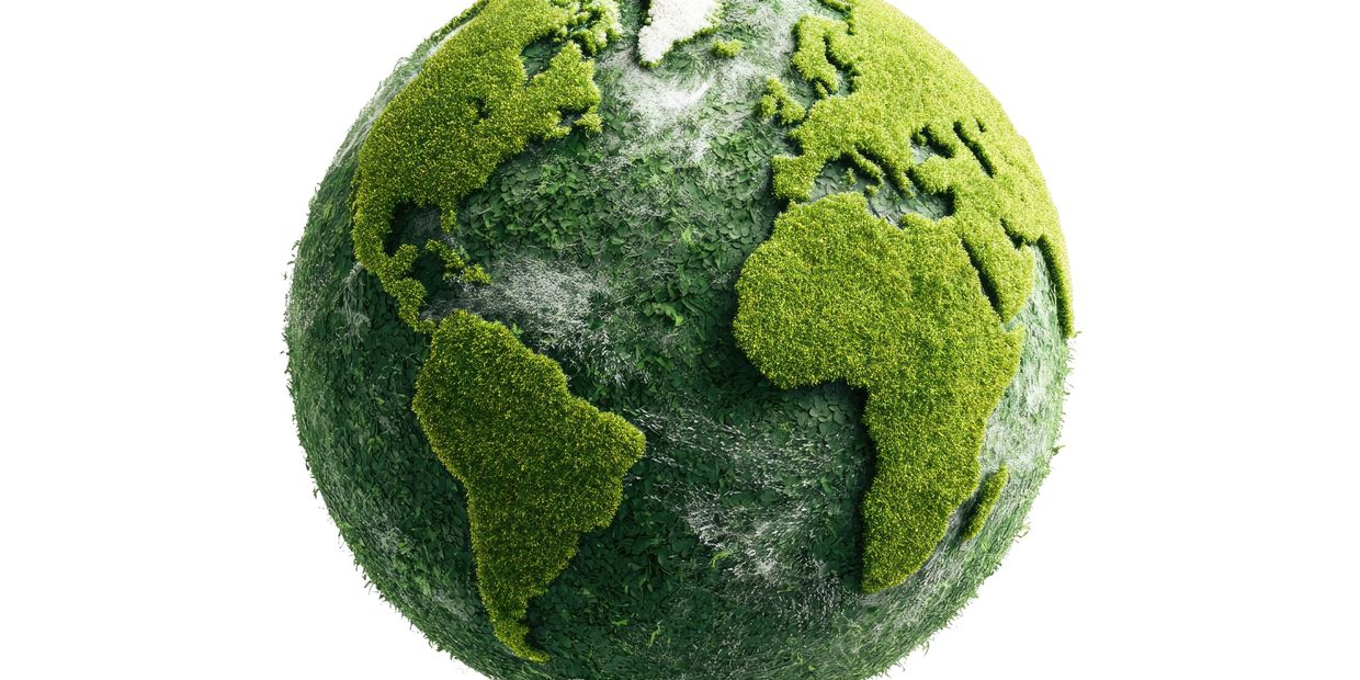 Earth globe covered with green foliage representing continents.