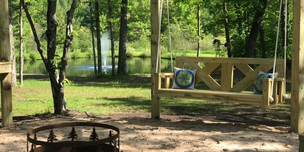 Fire Pit area at Pine Creek Cove features swings and lights.