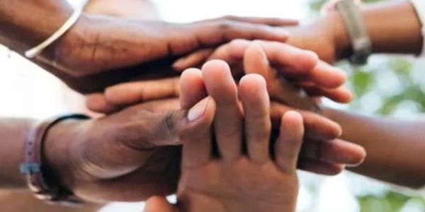 Hands stacked together showing unity.