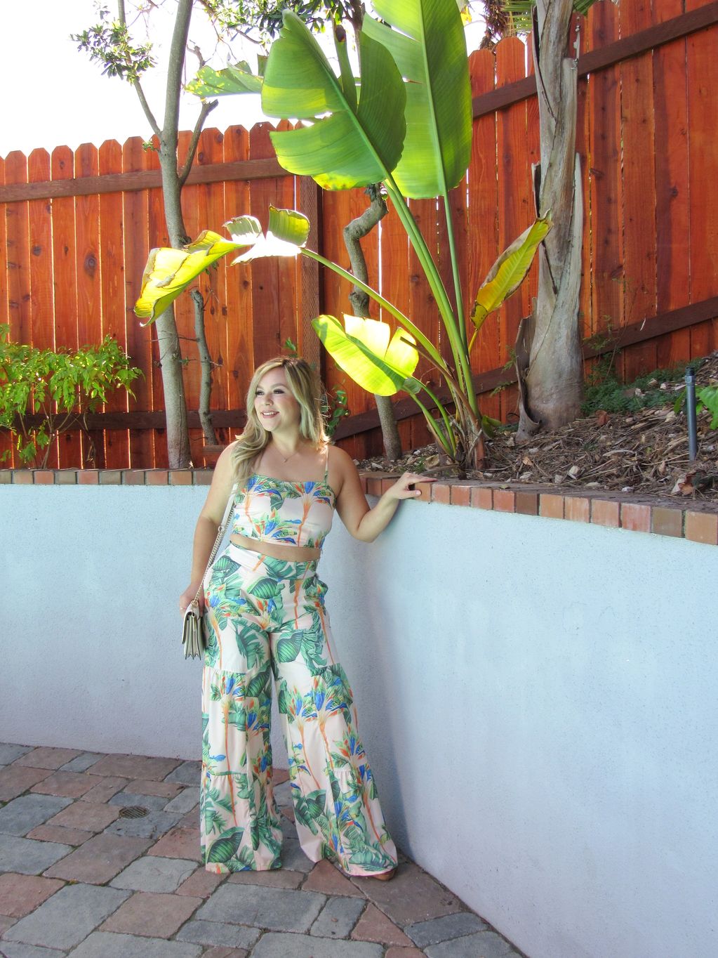 Woman dressed in tropical pant set outside