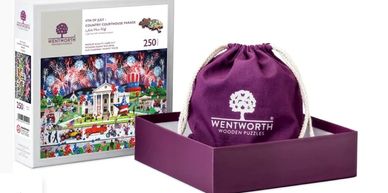 250-piece patriotic puzzle with fireworks and landmarks, including a purple storage bag.