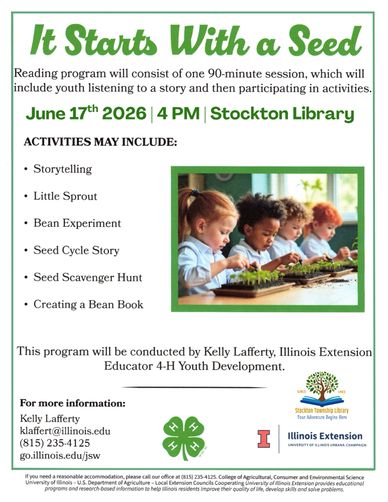 Children engaged in a seed planting activity at a library event.