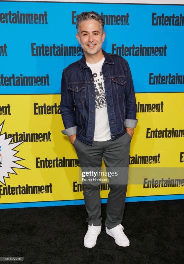 Man posing at Entertainment Weekly event.