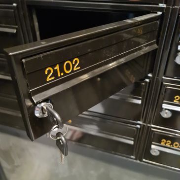 <img  src="apartment mailbox.jpg"  alt-"communal building apartment mailbox opening lock replace">