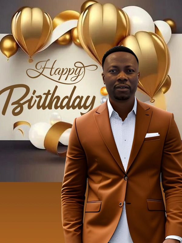 Man in brown suit with gold and white birthday balloons.