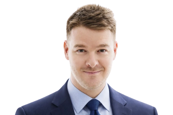 Professional man in blue suit and tie smiling.